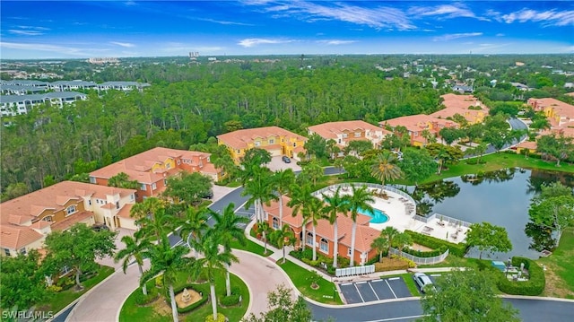 birds eye view of property featuring a water view, a residential view, and a wooded view