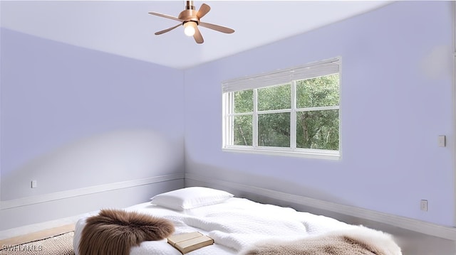 bedroom featuring a ceiling fan and baseboards