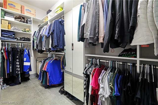 walk in closet featuring tile flooring