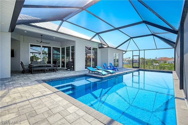 view of pool featuring a patio, a lanai, an outdoor living space, and ceiling fan