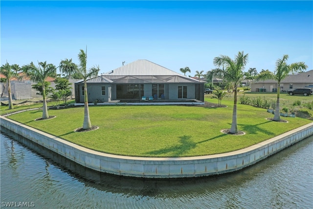 back of house with a lanai, a water view, and a yard