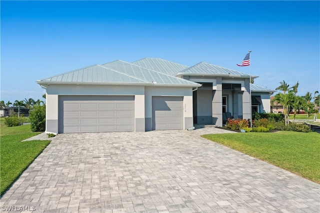 view of front of home with a garage and a front yard