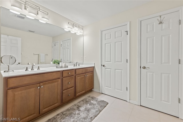 bathroom with tile patterned flooring and vanity