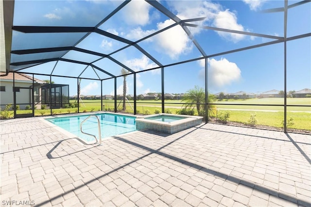 view of pool featuring a lanai, a patio, and an in ground hot tub