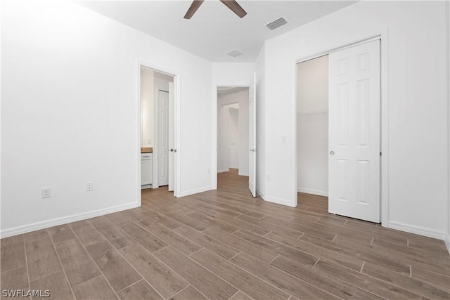 unfurnished bedroom with ceiling fan and a closet