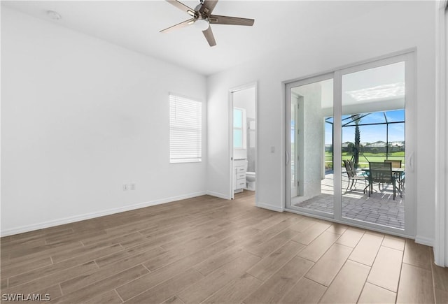 spare room featuring ceiling fan and light wood-type flooring