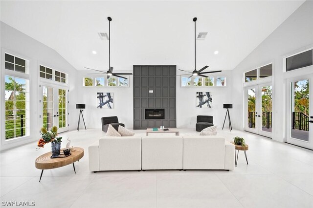 living room with ceiling fan, french doors, a healthy amount of sunlight, and lofted ceiling