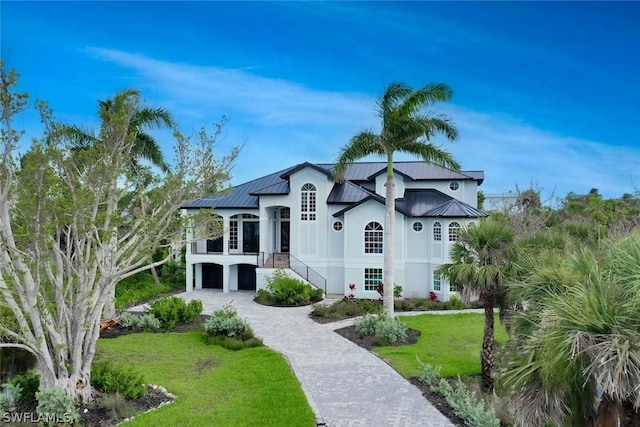 view of front of home featuring a front yard and a garage