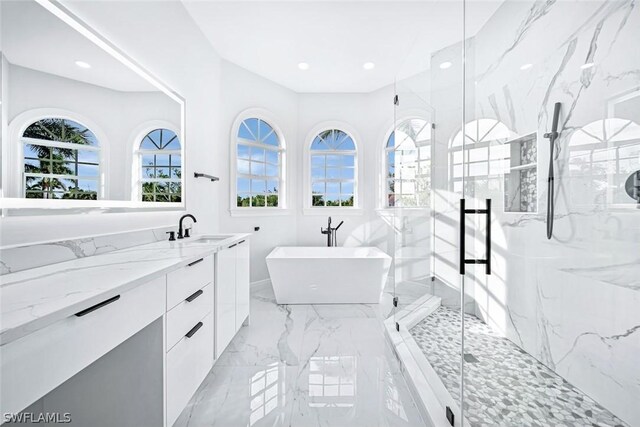 bathroom with independent shower and bath and vanity