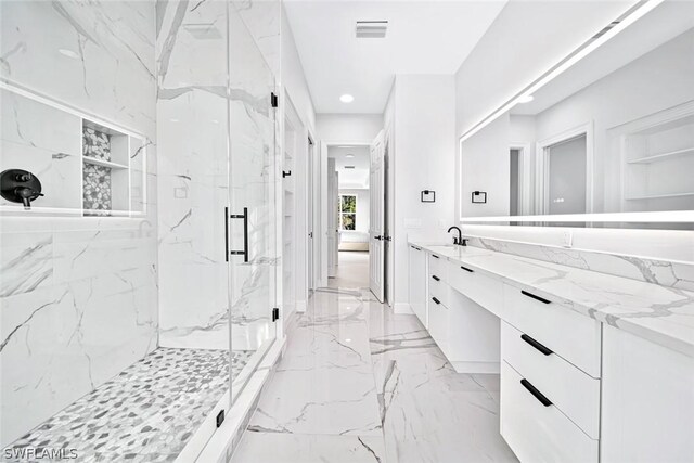 bathroom with an enclosed shower and vanity