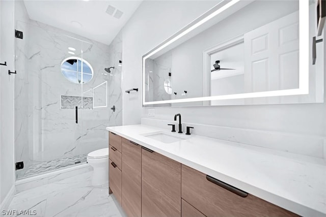 bathroom with toilet, a shower with shower door, and vanity