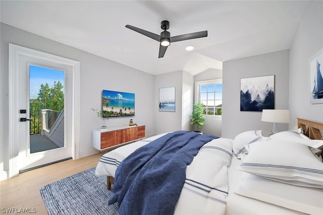 bedroom with ceiling fan, access to exterior, light hardwood / wood-style flooring, and vaulted ceiling