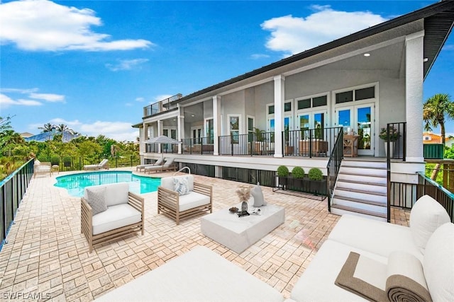 view of pool with a patio area and a fire pit