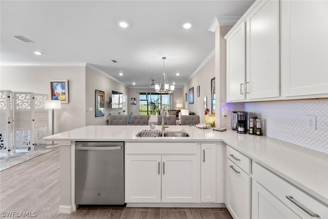 kitchen featuring white cabinetry, sink, stainless steel dishwasher, a notable chandelier, and kitchen peninsula