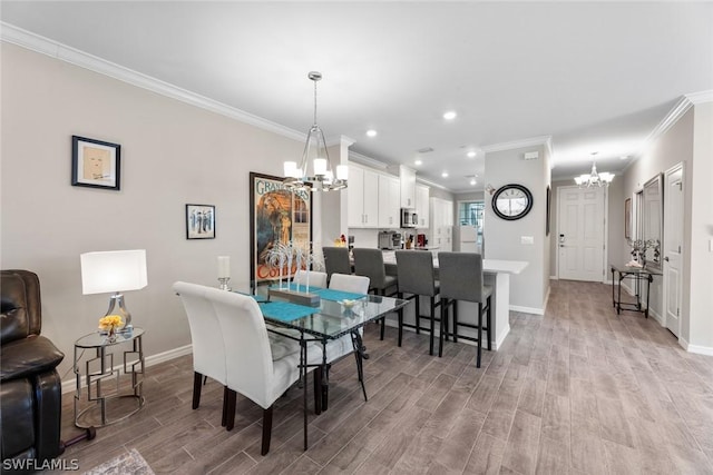 dining space featuring a notable chandelier, light wood-type flooring, and ornamental molding