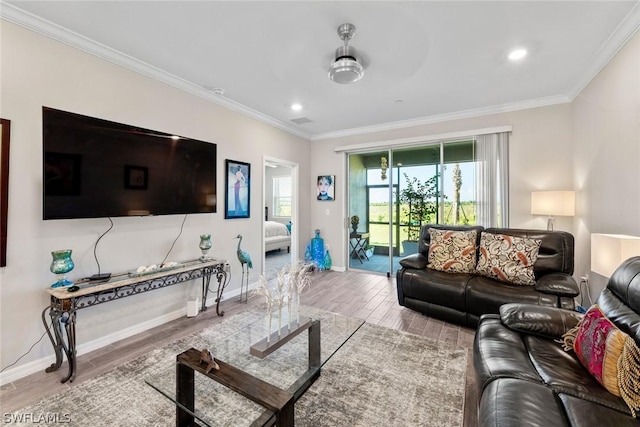 living room featuring ceiling fan and crown molding