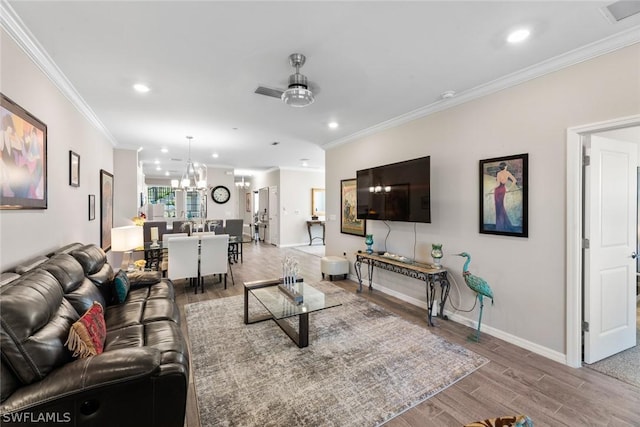 living room with ceiling fan and crown molding