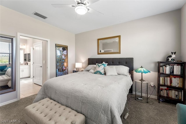 carpeted bedroom featuring ensuite bath and ceiling fan