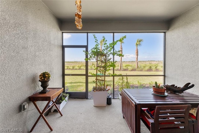 sunroom featuring a rural view