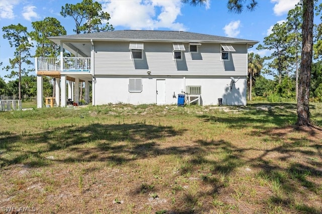 rear view of house featuring a yard