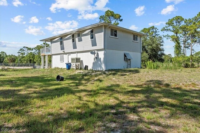 view of property exterior featuring a yard and a balcony