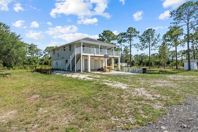 back of property featuring a deck and a lawn