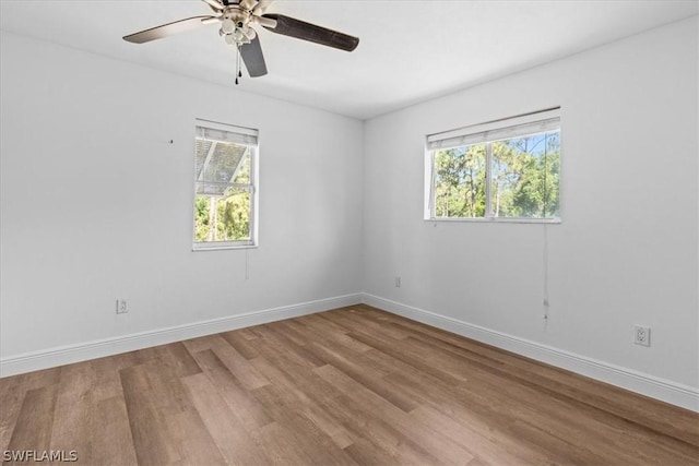 empty room with ceiling fan and wood-type flooring