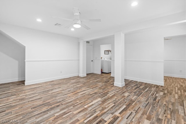 basement with ceiling fan, washer / clothes dryer, and hardwood / wood-style flooring