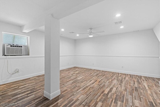 basement featuring dark hardwood / wood-style flooring and ceiling fan