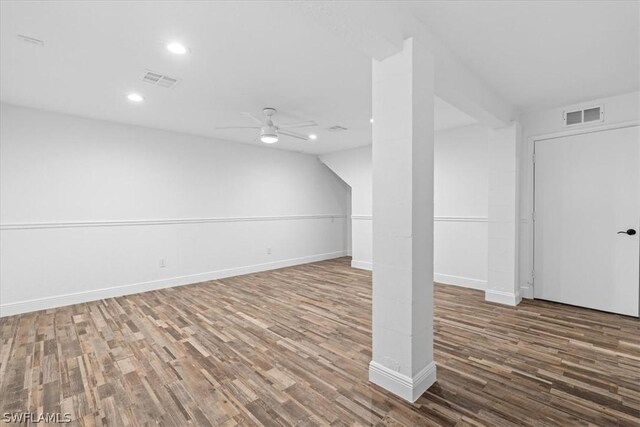 basement featuring ceiling fan and dark hardwood / wood-style flooring