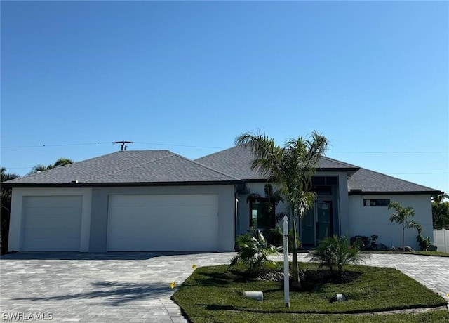 ranch-style house featuring a front lawn and a garage