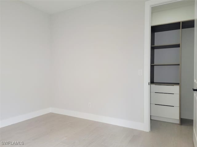 interior space featuring light wood finished floors and baseboards