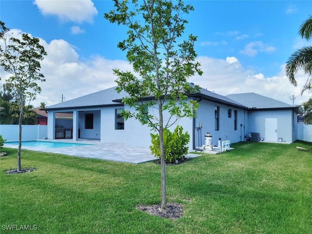 back of property featuring a yard, stucco siding, fence, and a patio