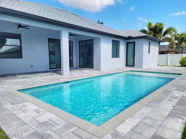 view of swimming pool with a patio area, fence, a ceiling fan, and a fenced in pool