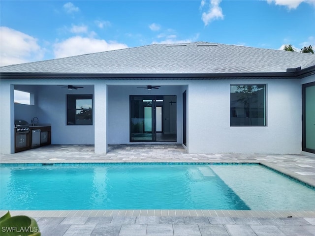 outdoor pool with ceiling fan, a patio, an outdoor kitchen, a sink, and a grill