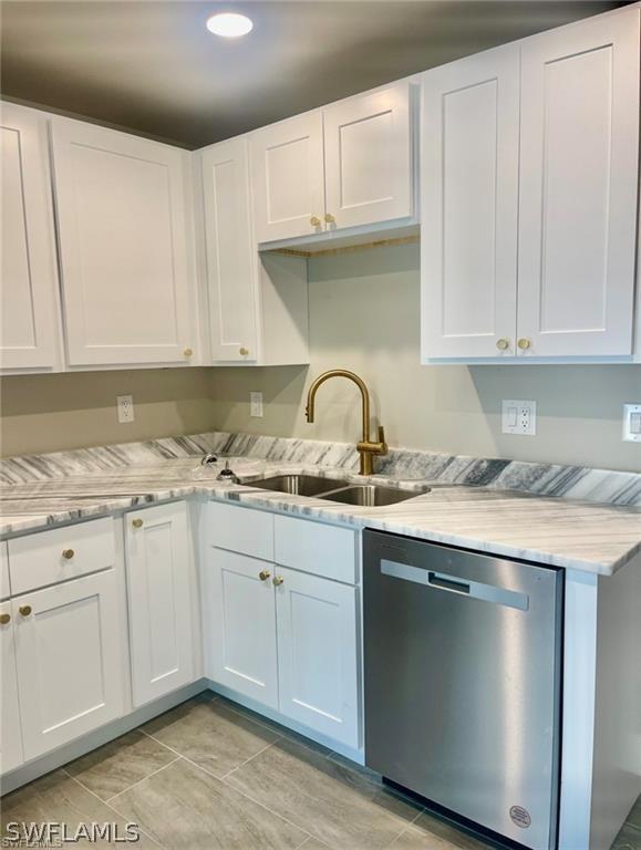 kitchen featuring white cabinetry, sink, and stainless steel dishwasher