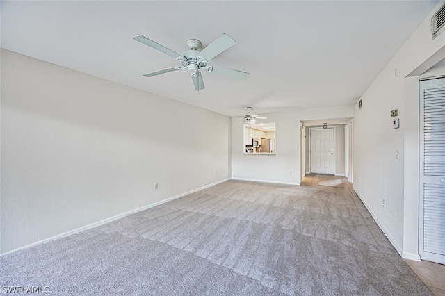 unfurnished living room featuring carpet flooring and ceiling fan