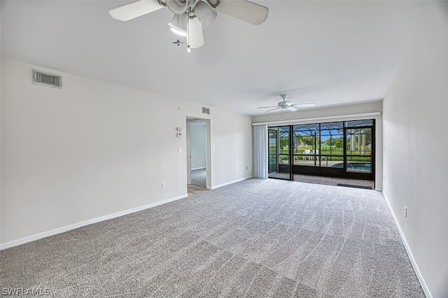 empty room with ceiling fan and carpet