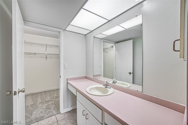 bathroom featuring tile patterned flooring and vanity