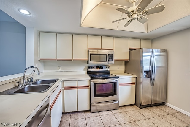 kitchen featuring ceiling fan, sink, light tile patterned floors, and stainless steel appliances