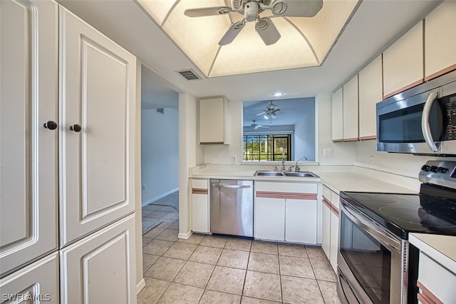 kitchen featuring stainless steel appliances, ceiling fan, sink, white cabinets, and light tile patterned flooring