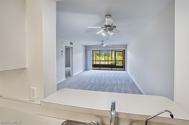 interior space featuring carpet floors and ceiling fan