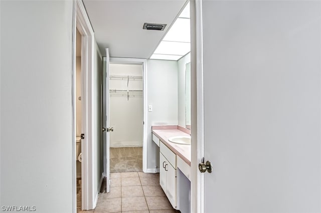 bathroom featuring tile patterned flooring, vanity, and toilet