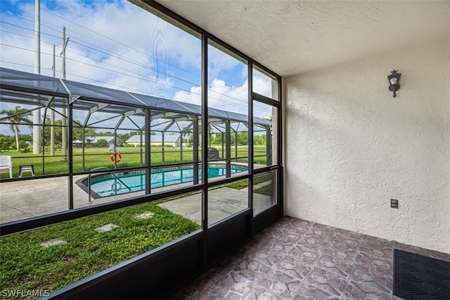 unfurnished sunroom with a pool