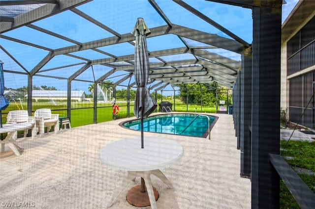 view of pool featuring glass enclosure and a patio area