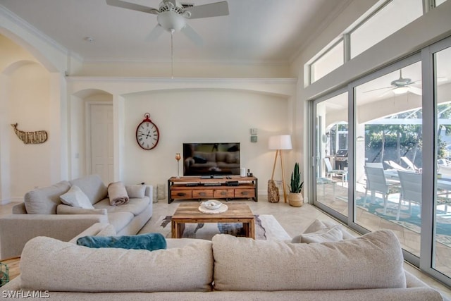 living room with ceiling fan and crown molding