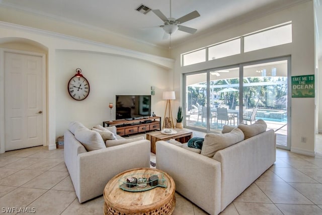 tiled living room featuring ceiling fan and crown molding