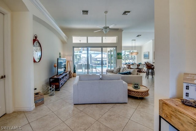 living room featuring light tile patterned floors, a wealth of natural light, ceiling fan, and crown molding