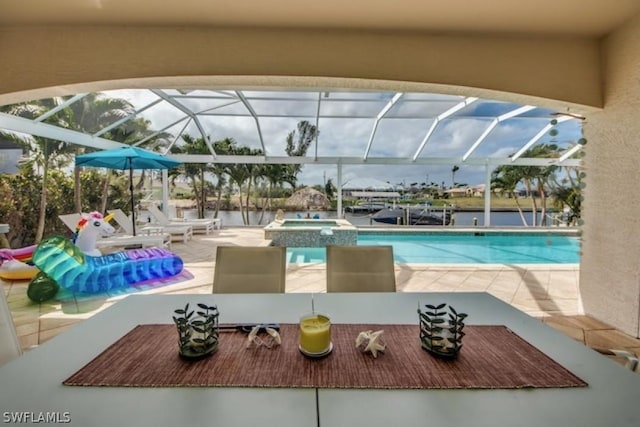 view of swimming pool with an in ground hot tub, a patio, and glass enclosure