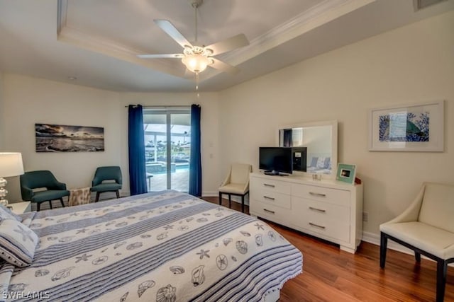 bedroom with access to outside, a raised ceiling, ceiling fan, crown molding, and wood-type flooring